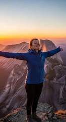Joyful Woman on Mountain Peak at Sunrise