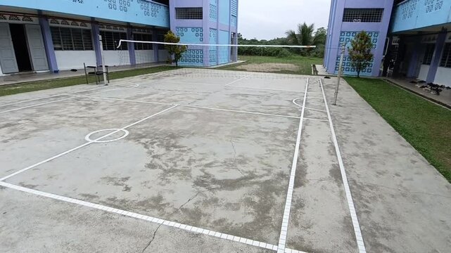 sepaktakraw or takraw ball  or buka ball, kick volleyball or foot volleyball old  court with net and white lines on a sunny day. photo taken in malaysia