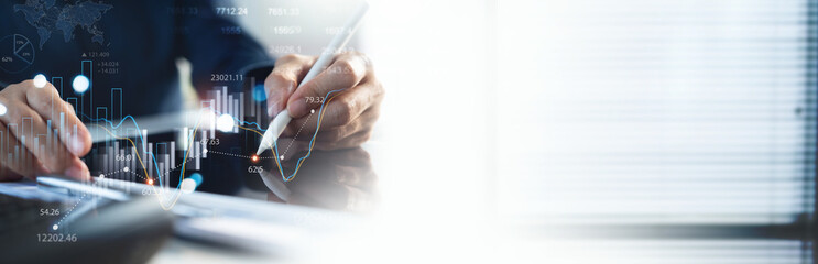 Business, finance and investment concept. Businessman using digital tablet analyzing and...