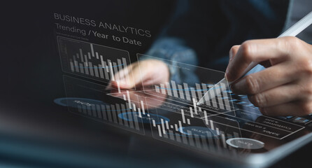 Businessman using digital tablet analyzing sales data and financial growth graph chart report....