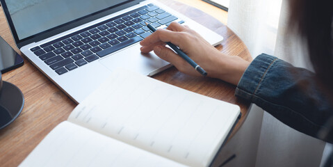 Business woman working on laptop computer for online research and schedule agenda planning on...