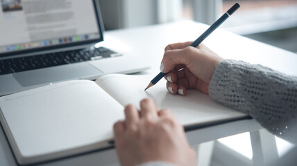 E-learning, online study, on line working from home concept. Business woman with a pen in hand...