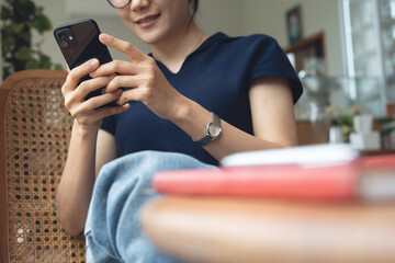 Business woman using mobile phone and laptop computer searching internet social networks or remote...