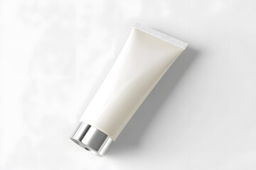 White cosmetic tube with metallic cap, minimal design on light background. Clean branding for lotion, sunscreen, or skincare products.