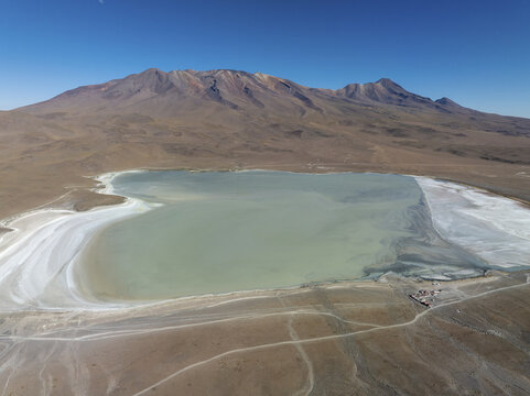 Aerial view of the shimmering Laguna Celeste mirroring the stark desert landscape under a clear sky, San Pablo de L&Atilde;&shy;pez, Potosi Department, Bolivia.