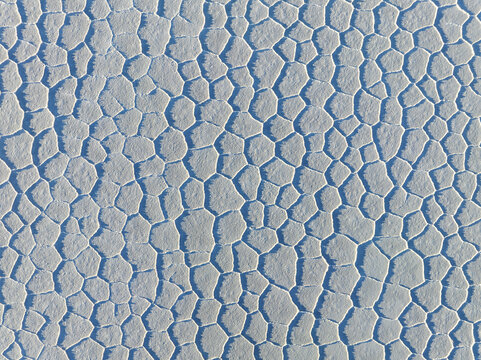 Aerial view of a mesmerising mosaic of polygonal salt flats, reflecting the sky's soft light in geometric perfection, San Pablo de L&Atilde;&shy;pez, Potosi Department, Bolivia.
