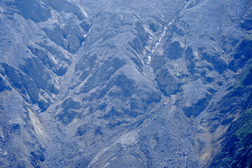 Close-up of rock with gravel and glacier at mountain named Kleines Nesthorn seen from Lauchernalp...
