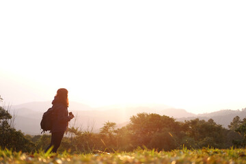 Asian young woman backpack holding camera and standing with wildflower and beautiful landscape of valley Doi Luang Chiang Dao mountain, Chiang Mai Province of Thailand 