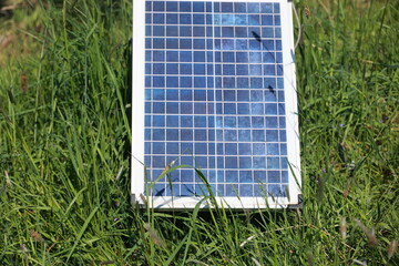 A solar panel is sitting on the grass