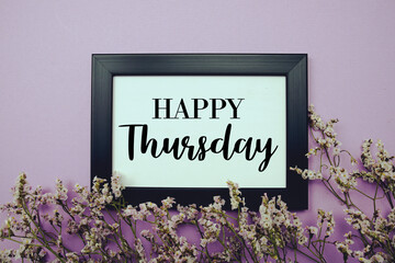 Happy Thursday text with flowers bouquet decoration on purple background