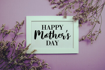 Happy Mother's Day text with flowers bouquet decoration on purple background