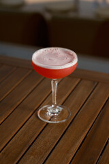 Refreshing Pink Lady cocktail. Gin, grenadine, lemon, egg white. Classic drink. Stock photo.