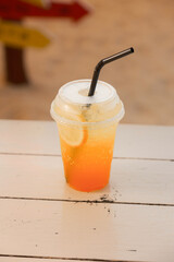 Refreshing orange soda with lemon slice. Fizzy drink, citrus, summer beverage. Bright, cold, sweet.