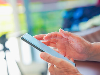 Close up hand people using smartphone browsing internet, business, text or online shopping. Senior...