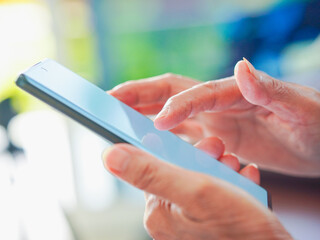Close up hand people using smartphone browsing internet, business, text or online shopping. Senior...