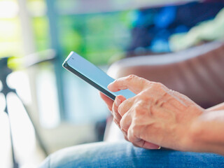 Close up hand people using smartphone browsing internet, business, text or online shopping. Senior...