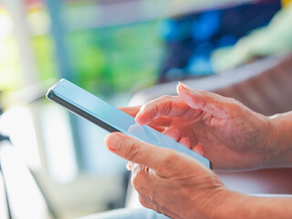Close up hand people using smartphone browsing internet, business, text or online shopping. Senior...