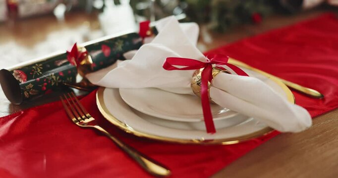 Christmas, decoration and setting on table for lunch, dinner and feast for holiday celebration. December, dining room and plate with napkin, ribbon and crackers for tradition, festive season and xmas