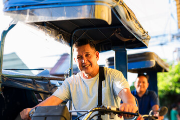 Friendly Filipino Tricycle Drivers, smiling warmly while waiting for passengers. A typical scene in Metro Manila, Philippines.