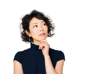 A woman in her thirties with an expression of sadness, thinking and contemplation, standing against a white background, hands under her chin, deep in thought. She is wearing navy blue