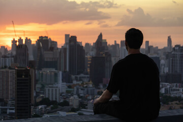 Outline of a man against sunset in Bangkok