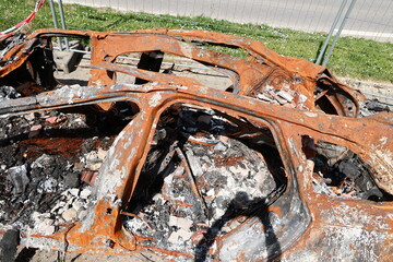 A car is on fire and has been destroyed