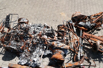 A pile of rusted metal and burnt debris