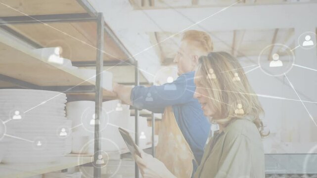 Woman scrolling tablet app prompts man inspecting plates on shelves, updating with data icons