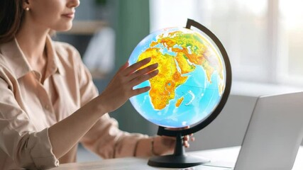 Woman studying world globe - Powered by Adobe