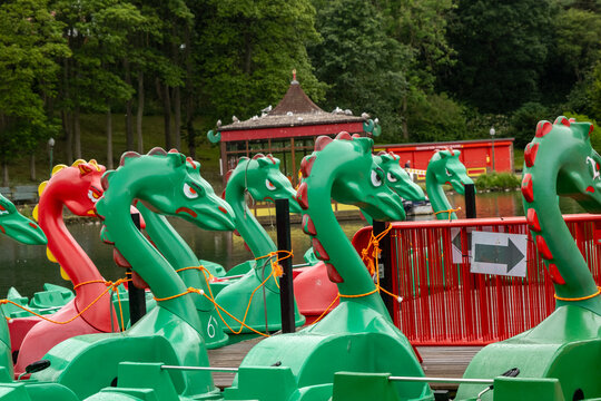 Dragon pedal boats tied up ready for hire on the boating lake in Peasholm Park, Scarborough