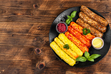 Fresh uncooked sausages on a plate.