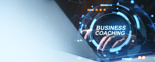 Business coaching concept with futuristic digital interface and hands typing on laptop keyboard on...