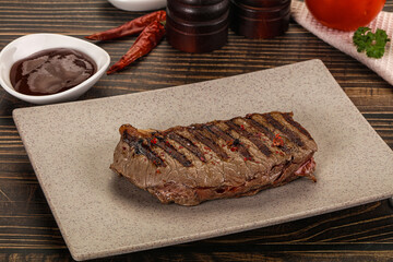 Grilled beef striploin steak with sauce