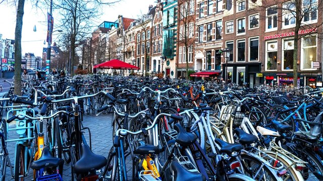 A sea of bicycles parked in a crowded rack on a typical street in Amsterdam, Netherlands, showcasing the city's famous bike culture