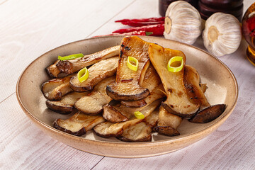 Roasted eringi mushrooms in the plate