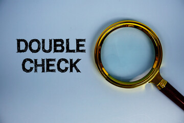Double Check text with magnifying glass on blue background