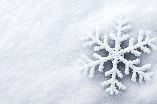 Detailed shot of a unique snowflake resting on snow