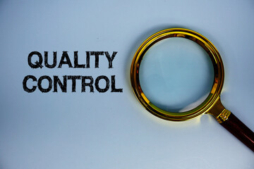Quality Control text with magnifying glass on blue background