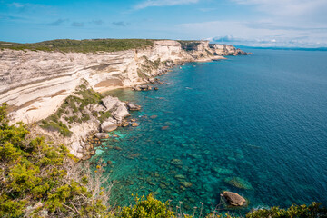 White limestone cliffs along Promenade des Falaises overlook the turquoise sea below near Bonifacio