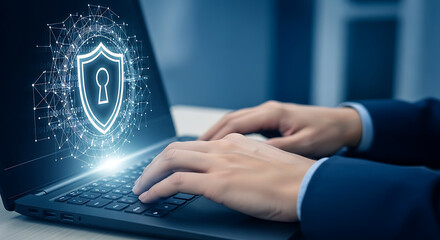 Hands typing on a laptop with a glowing digital shield icon for security