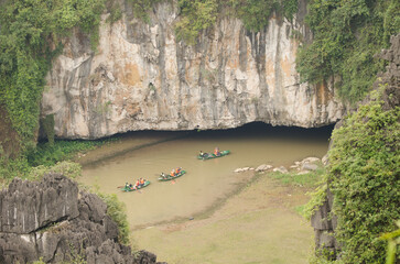 March 1, 2024, Ninh Binh Province: Boats with tourists entering a cave in the Ngo Dong River. Vietnam.