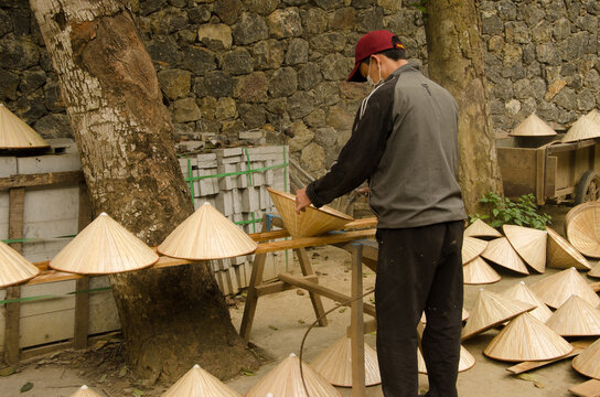Man making the popular headgear of Vietnamese people. Hoa Lu District. Ninh Binh Province. Vietnam.
