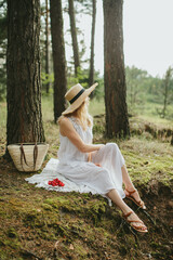 Woman relaxing in forest enjoying fresh cherries and nature