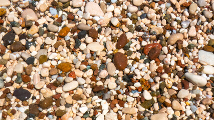 Pebbles on a beach washed by undertow water
