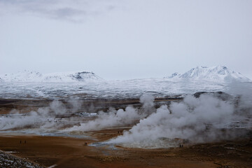 Hverir is a geothermal field in North Iceland, filled with bubbling mud pools, steaming fumaroles, and colorful sulfur-stained earth.