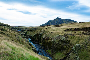 Skógafoss is a mighty waterfall, often seen with rainbows. Follow the trail above to discover many more hidden cascades along the river.