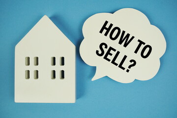 How to Sell? text with house model and magnifying glass on blue background