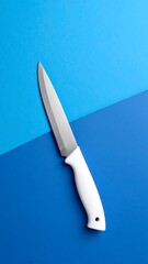 Sharp kitchen knife on blue background