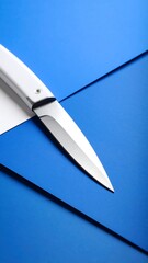 Sharp white knife on blue surfaces