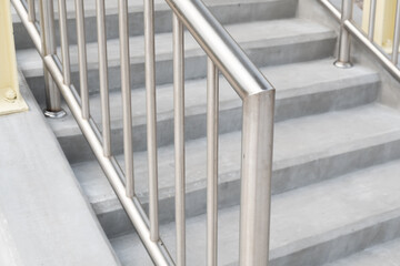 Stainless steel handrails on the stairs leading up to the building.